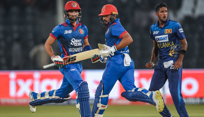 Afghanistan’s Ibrahim Zadran (left) and Gulbadin Naib (C) run between the wickets during the Asia Cup 2023 one-day international (ODI) cricket match between Sri Lanka and Afghanistan at the Gaddafi Stadium in Lahore on September 5, 2023. — AFP