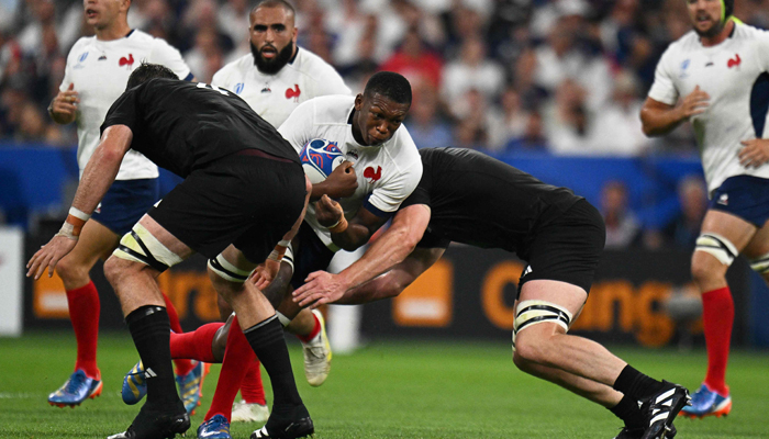 Frances lock Cameron Woki (C) is tackled during the France 2023 Rugby World Cup Pool A match between France and New Zealand at the Stade de France in Paris on September 8, 2023. — AFP