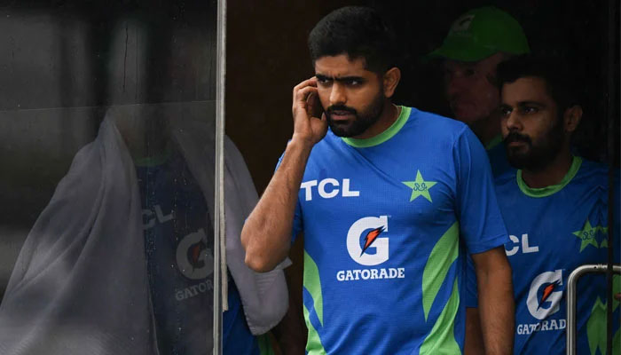 Pakistans captain Babar Azam (second left) waits near a room as rain delays the Asia Cup 2023 super four one-day international (ODI) cricket match between India and Pakistan at the R. Premadasa Stadium in Colombo on September 11, 2023. — AFP