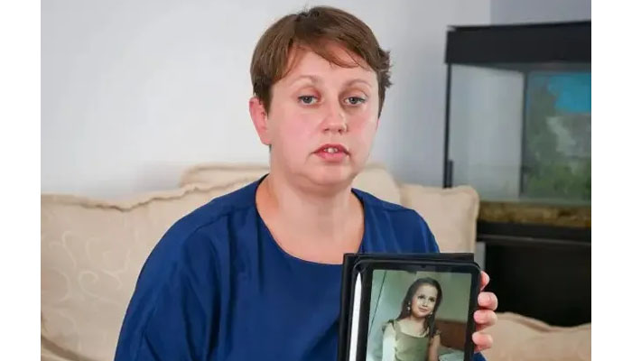 Sara Sharifs mother Olga Sharif holding her daughters picture. — AFP