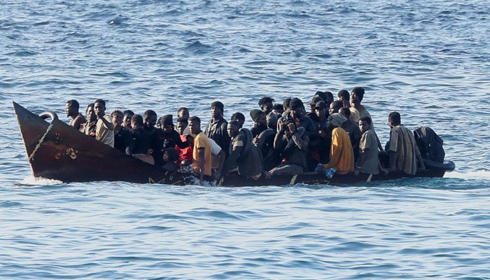 A migrant boat carrying refugees to Italy. — AFP