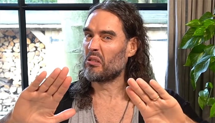 Russell Brand arrives at comedy show amid assault allegations.