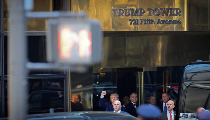 Former US President Donald Trump pumps his fist as he departs Trump Tower for his arraignment on April 04, 2023, in New York, New York. — AFP