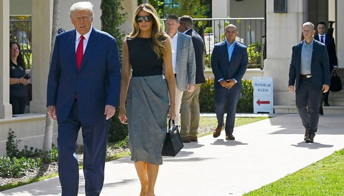 Former US President Donald Trump and former US First Lady Melania Trump depart a polling station after voting in the US midterm elections at Morton and Barbara Mandel in Palm Beach, Florida, on November 8, 2022. — AFP