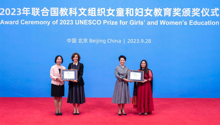 Peng Liyuan, UNESCO special envoy for the advancement of girls and womens education, and Audrey Azoulay, director-general of UNESCO, present awards to representatives of China Children and Teenagers Fund (CCTF) (L) and Pakistan Alliance for Girls Education (PAGE) at the award ceremony of the UNESCO Prize for Girls and Womens Education 2023 in Beijing, on September 28, 2023. — Xinhua/File