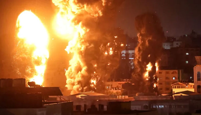 Fire and smoke rise above buildings in Gaza City as Israeli warplanes target the Palestinian enclave, early on May 17, 2021. — AFP