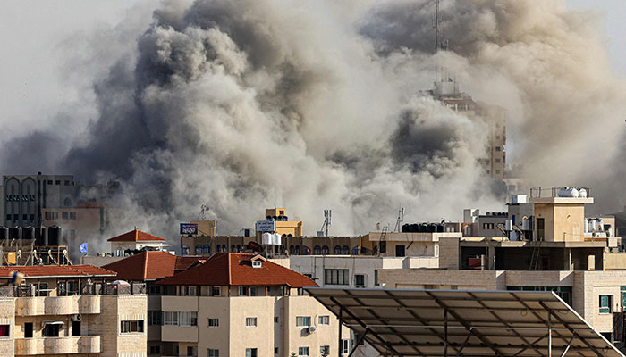 Smoke plumes rise over Gaza City on October 7, 2023 during Israeli air strikes. — AFP