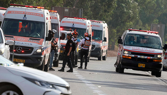 Israeli rescue teams wait next to ambulances parked just outside the southern city of Sderot to evacuate the wounded on October 7, 2023. — AFP