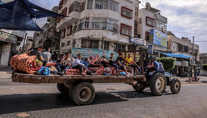 Palestinians flee Gaza City following Israeli air strikes on October 7, 2023. — AFP