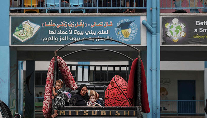 Palestinians fleeing Israeli air strikes take refuge in a school run by the United Nations in Gaza City on October 7, 2023. — AFP