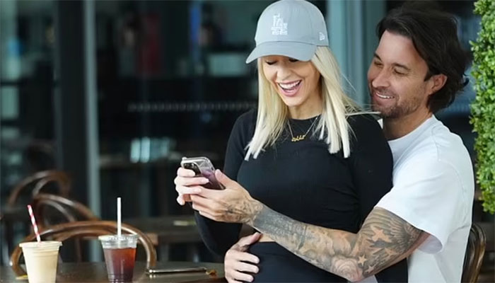 Michael Turnbull with pregnant partner Charlotte Cushing during Brisbane coffee outing.