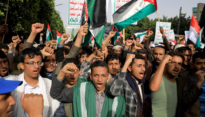 People wave Palestinian flags as they take to the streets of Yemens Houthi-held capital Sanaa on October 7, 2023, in support of the Palestinians on October 7, 2023. — AFP