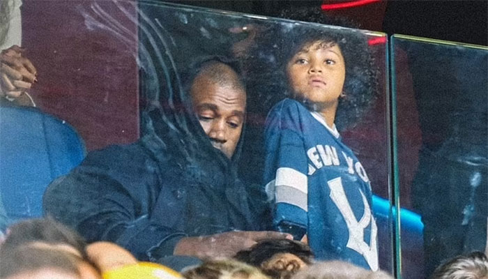 Kanye Wests father-son time with seven-year-old Saint at Italy soccer game.