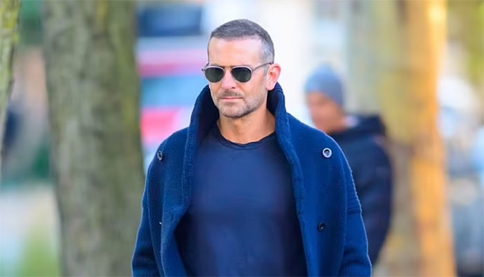 Bradley Coopers stylish navy look in NYC amid blossoming romance with Gigi Hadid.