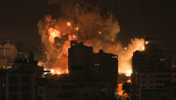 Fire and smoke rise above buildings in Gaza City during an Israeli airstrike on October 8, 2023. — AFP