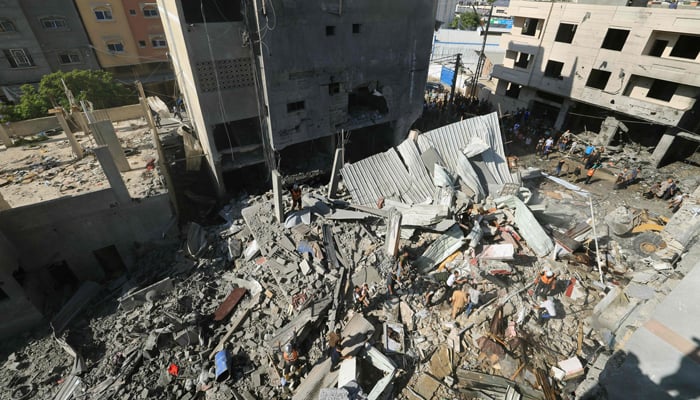 Palestinians search for victims in the rubble of a building after an Israeli strike in Khan Yunis in the southern Gaza Strip on October 17, 2023. — AFP