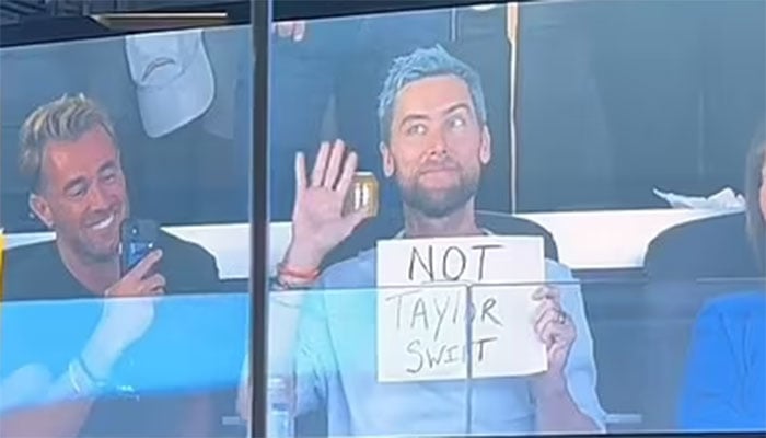 Lance Bass teases swifties with NOT Taylor Swift sign at Chargers game.