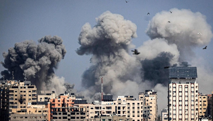 Smoke plumes billow over Gaza City after Israeli airstrikes Thursday. — AFP