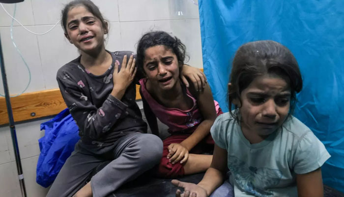 Palestinian children injured in an Israeli air strike await treatment at the Nasser hospital in Khan Yunis in southern Gaza, on 17 October 2023. — AFP