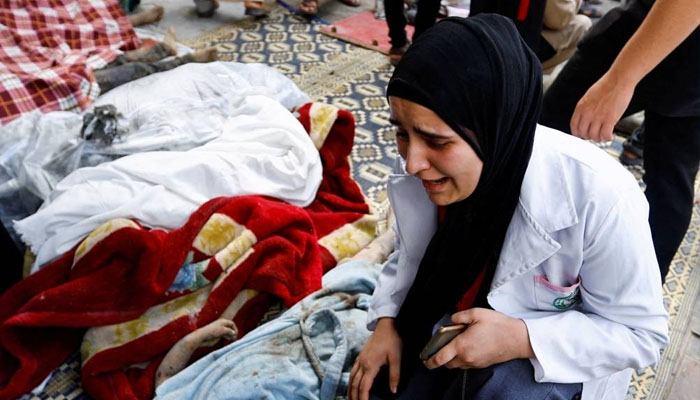 A woman reacts to the bodies of Palestinians killed in Israels attack on Tuesday. — AFP