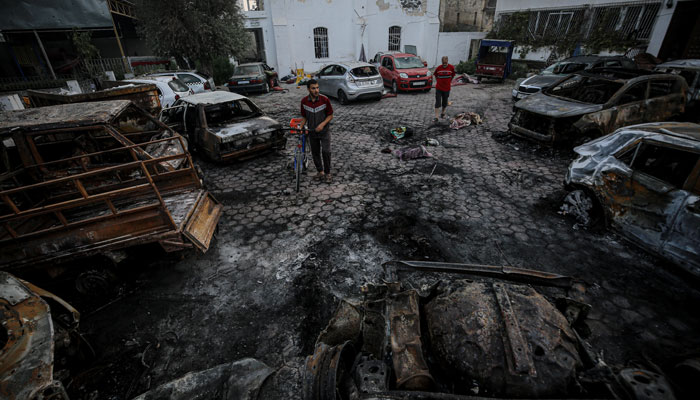 Palestinians wander the bombed compound of Al Ahli Hospital in northern Gaza a day after it was bombed by an Israeli air strike killing 500 Gazans on October 17, 2023. — Al Jazeera