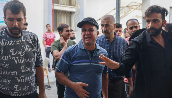 Palestinians mourn the death of relatives after overnight Israeli strikes on Rafah in the southern Gaza Strip on October 22, 2023 amid the ongoing battles between Israel and Palestinian groups. — AFP