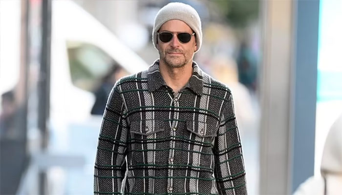 Bradley Cooper steps out in Gigi Hadids designer plaid shirt.