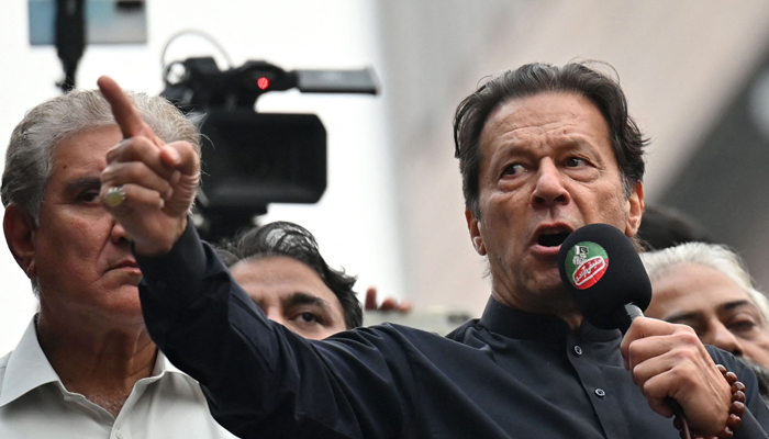 Former prime minister Imran Khan (right) addresses his supporters during an anti-government march towards Islamabad, in Gujranwala on November 1, 2022. — AFP