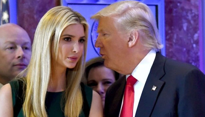 This photo taken on January 11, 2017 shows US President-elect Donald Trump whispers to his daughter Ivanka during a press conference at Trump Tower in New York. — AFP