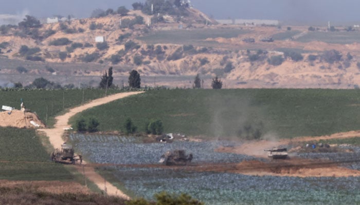 A picture taken from Israel´s southern city of Sderot shows Israeli tanks and bulldozers positioned in the north of the Gaza Strip, on October 30, 2023, amid ongoing battles between Israel and the Palestinian Hamas movement. — AFP