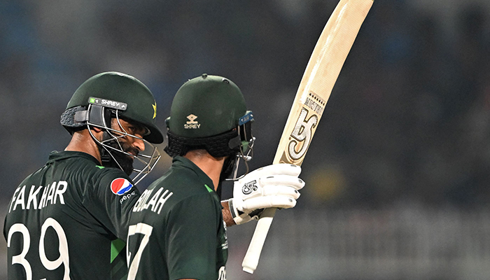 Pakistans Fakhar Zaman (left) celebrates after scoring a half-century as his teammate Abdullah Shafique watches during the World Cup match between Pakistan and Bangladesh at the Eden Gardens in Kolkata on October 31, 2023. — AFP