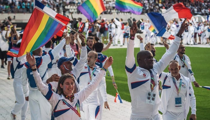 Members of the French team march onto the field during the opening ceremony of the 2018 Gay Games in Paris. — AFP