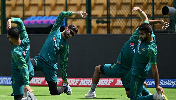 Pakistans cricketers stretch during a practice session at the M. Chinnaswamy Stadium in Bengaluru on November 3, 2023. — AFP