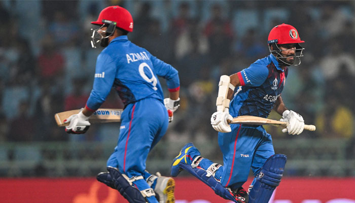 Afghanistan´s captain Hashmatullah Shahidi (right) and Azmatullah Omarzai run between the wickets during the World Cup match between Netherlands and Afghanistan at the Ekana Cricket Stadium in Lucknow on November 3, 2023. — AFP