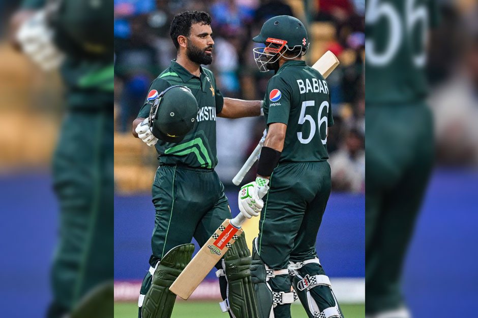 Pakistan´s Fakhar Zaman celebrates with his captain Babar Azam (right) after scoring a century during the World Cup match between New Zealand and Pakistan at the M. Chinnaswamy Stadium in Bengaluru on November 4, 2023. — AFP