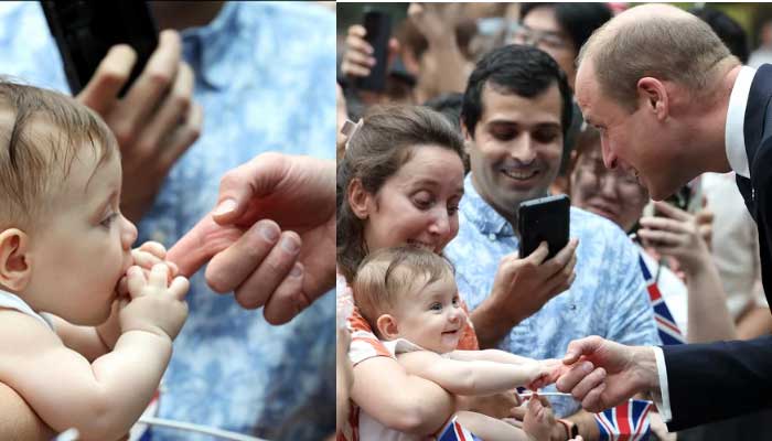 Baby bites Prince Williams finger as he chats with her mother in Singapore