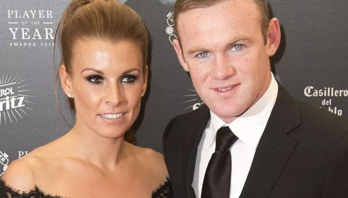 Wayne Rooney and Coleen Rooney gesture during a sports gathering. — AFP/File