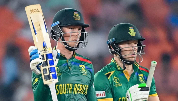 South Africas Rassie van der Dussen (left) raises his bat after scoring a half-century while David Miller stands next to him during the World Cup 2023 match between South Africa and Afghanistan at Ahmedabads Narendra Modi Stadium on November 10, 2023. — AFP