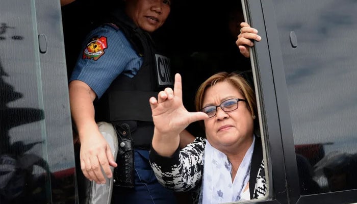 Philippine Senator Leila de Lima, a former human-rights commissioner who is one of Dutertes most vocal opponents, waves to her supporters after appearing at a court in Muntinlupa City, suburban Manila, on Feb. 24, 2017. — AFP