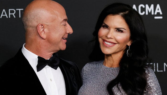 Lauren Sanchez and Jeff Bezos gesture during a gathering. — AFP/File