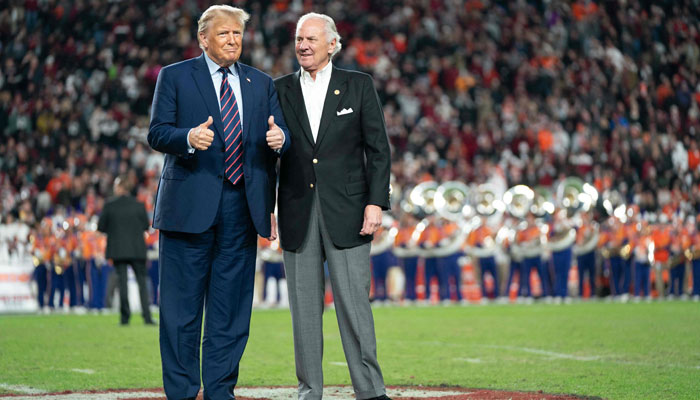 (L-R) Former US president Donald Trump joins South Carolina Gov. Henry McMaster on the field during halftime in the Palmetto Bowl between Clemson and South Carolina at Williams Brice Stadium on November 25, 2023, in Columbia, South Carolina. — AFP