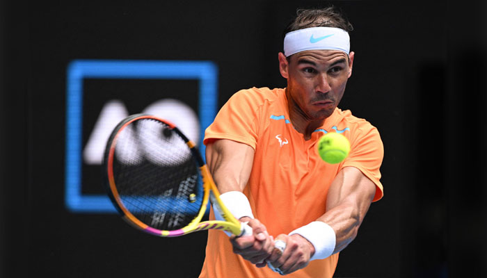Spains Rafael Nadal hits a return against Britains Jack Draper during their mens singles match on day one of the Australian Open tennis tournament in Melbourne on January 16, 2023. — AFP