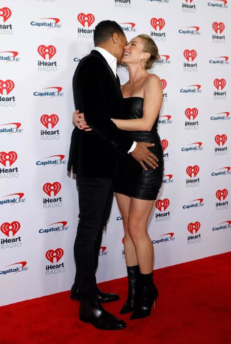 Amy Robach, T.J. Holmes proudly pack PDA at Jingle Ball red carpet