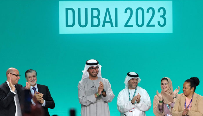 COP28 president Sultan Ahmed Al Jaber applauds among other officials before a plenary session during the United Nations climate summit in Dubai, United Arab Emirates, Dec 13, 2023. — AFP