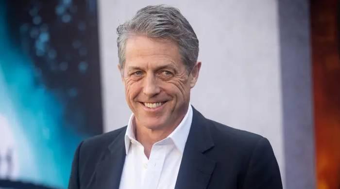 Hugh Grant quips he spends his downtime 'swamped' with children