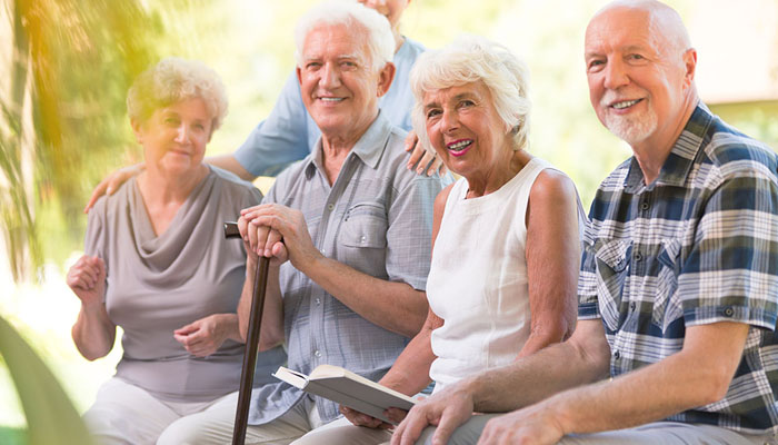 A group of US senior citizens sitting in a park. — X/@asleycourtcare