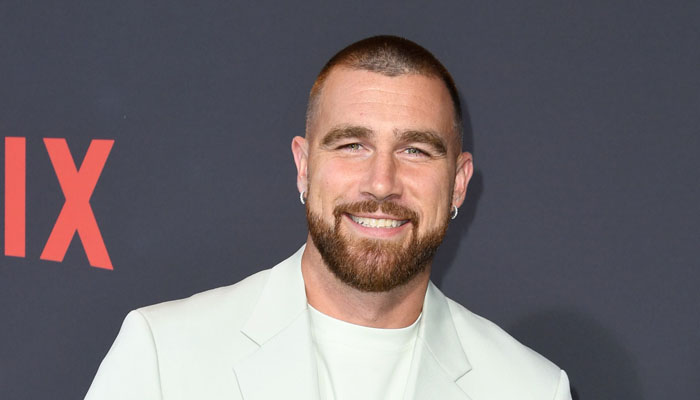 Travis Kelce gestures during a gathering. — X/@cosmopolitan