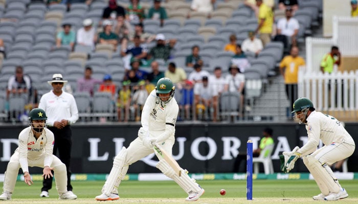 Australia´s Usman Khawaja (C) plays a shot during day three of the first Test cricket match between Australia and Pakistan in Perth on December 16, 2023. — AFP