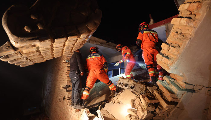 Rescue workers search a house for survivors after an earthquake in Kangdiao village, Dahejia, Jishishan County, in northwest Chinas Gansu province on December 19, 2023. — AFP