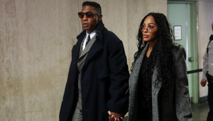 Jonathan Majors and Meagan Good hold hands